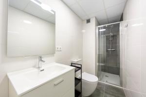 a white bathroom with a sink and a shower at Trendy Homes Almeria Center in Almería