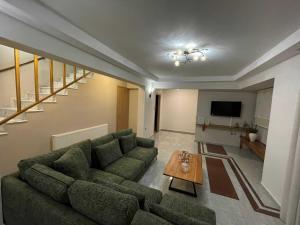 a living room with a couch and a table at Villa Dino in Kalithies