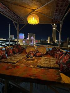 a group of pillows on a table with a view of the city at LAYALI Boutique in Bukhara
