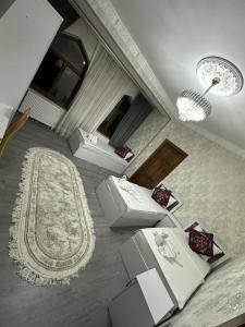 a living room with two toilets and a rug at LAYALI Boutique in Bukhara