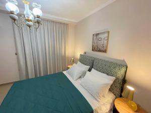 a bedroom with a bed and a chandelier at Villa Dino in Kalithies +58 photos
