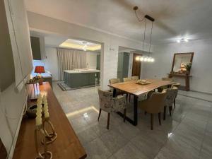 a dining room with a wooden table and chairs at Villa Dino in Kalithies