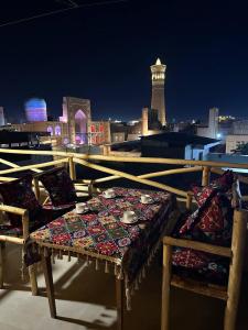 a table with bowls and plates on it on a roof at LAYALI Boutique in Bukhara