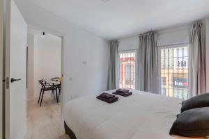 a bedroom with a large bed with two pillows on it at Trendy Homes Almeria Center in Almería