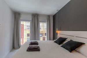 a bedroom with a large white bed with two pillows at Trendy Homes Almeria Center in Almería