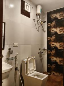 a bathroom with a toilet and a sink at Waves P'opin Resort in Mahabalipuram