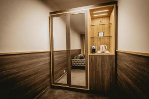 a mirror in a room with a chair in it at Hotel ZOO Sofia in Sofia