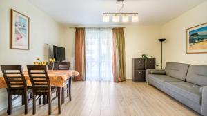 a living room with a table and a couch at Osiedle Bursztynowe in Jantar