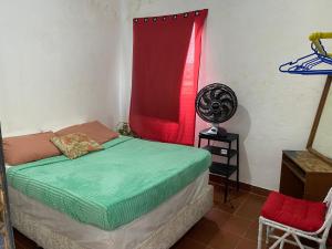 a bedroom with a bed and a red window at Carioca Lapa Hostel in Rio de Janeiro
