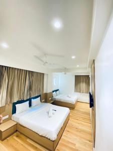 a bedroom with two beds in a room at Hotel Sun City in Kalol