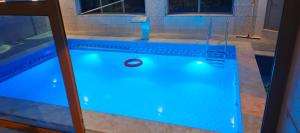 a swimming pool with a blue pool at Top "OverView" Resort اطلالة القمة in Al ‘Āmirīyah
