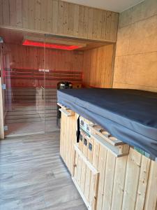 a room with a bed in a wooden room at Trzy Tarasy Swornegacie in Swornegacie