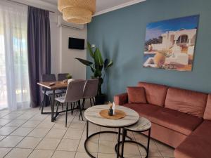 a living room with a couch and a table at Vryzas Resort in Ofrínion
