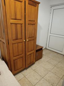 a bedroom with a wooden cabinet next to a bed at Villa Serenita in Ulcinj +147 photos
