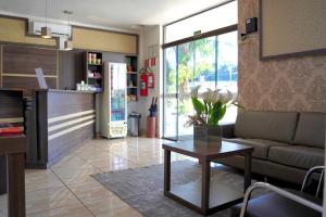 a living room with a couch and a table at Hotel Vivere Cataratas in Foz do Iguaçu +29 photos