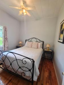 a bedroom with a bed with a ceiling fan at Dreamweavers Cottages and Vacation Homes in Rustico +200 photos