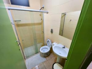 a bathroom with a shower and a toilet and a sink at Guarany Hotel Express in João Pessoa +37 photos
