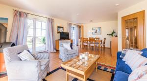 a living room with a couch and chairs and a table at Schleimündeblick in Olpenitz +10 photos