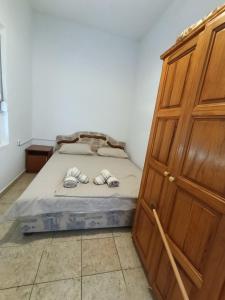 a bedroom with a bed and a wooden cabinet at Villa Serenita in Ulcinj