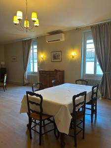 a dining room with a white table and chairs at Agen centre in Agen +11 photos