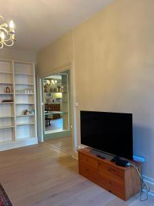 a living room with a flat screen tv on a wooden cabinet at Agen centre in Agen