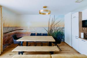 a dining room with a table and a view of the ocean at Beach SUN and FUN Penthouse in Podersdorf am See