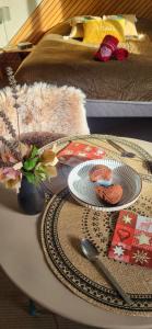 a coffee table with a plate and spoon on it at Ty KamBreiz in La Fresnais