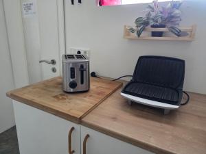 a kitchen counter with a toaster and a chair on it at Hrutafell Guesthouse in Hvolsvöllur