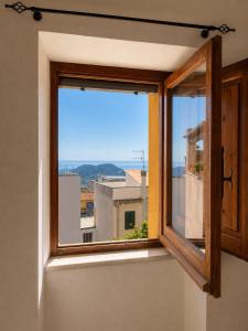 a window with a view of a city at Appartamento Martina in Lanusei