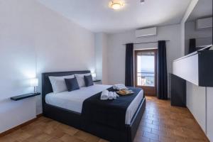 a bedroom with a bed and a television in a room at Appartamento Martina in Lanusei