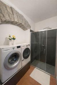 a washing machine in a bathroom with a shower at Appartamento Martina in Lanusei