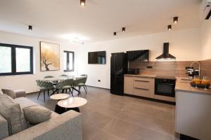 a kitchen and living room with a couch and a table at Tramontana Iž in Veli Iž