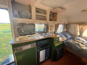 a kitchen in an rv with a sink and a sink at Weź Wyjdź - Podlaski Glamping in Łazy