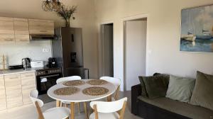 a living room with a table and a kitchen at Ria's Garden House in Kassiopi