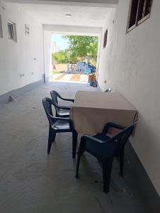 a table and two chairs in a room with a doorway at Villa Serenita in Ulcinj