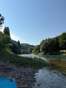 a view of a river with trees in the background at Sobe Dado, Gostionica Kod Dade in Banja Luka