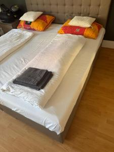 two beds with white blankets and pillows on them at Marivel Wohnung in Freudenstadt