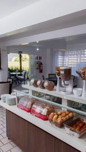 a bakery counter with pastries and other food items at Hotel Vivere Cataratas in Foz do Iguaçu
