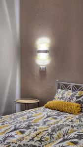 a bedroom with a bed with a yellow and white blanket at B&B di Cristina in Conegliano