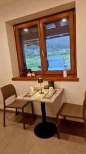 a table and a chair in a room with a window at MASO CLENA in Balbido-rango +29 photos