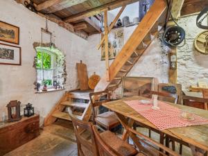 a dining room with a wooden table and chairs at Die Obermühle in Sangerhausen +12 photos