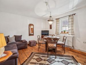 a living room with a couch and a table at Die Obermühle in Sangerhausen
