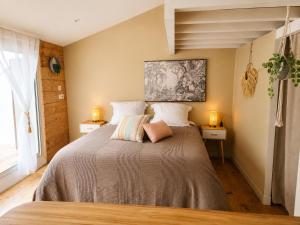 a bedroom with a large bed with two lamps at Plan B - Chambres & Studios in Saint-Jean-Pied-de-Port