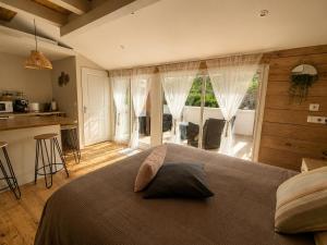 a bedroom with a large bed and a kitchen at Plan B - Chambres & Studios in Saint-Jean-Pied-de-Port +34 photos