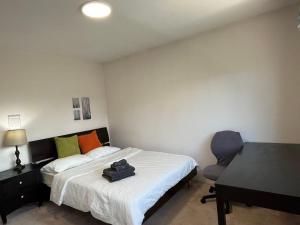 a bedroom with a bed and a desk and a chair at Home Base Quiet Queen Rooms in Richmond