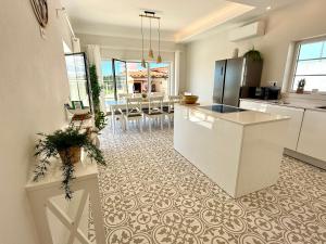 a kitchen with a white counter and a dining room at Villa Ericeira in Ericeira