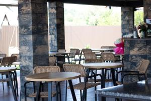 a row of tables and chairs in a restaurant at Luna in Solotvyno
