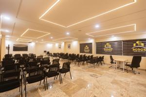 a room with rows of chairs and a projection screen at Dodos Hotel Services in Port Harcourt