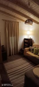 a bedroom with two beds and a table and a lamp at Cantinho do Frangoneiro in Fortios