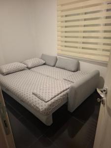 a small bed in a room with a window at Stan Milacic in Sutomore +12 photos